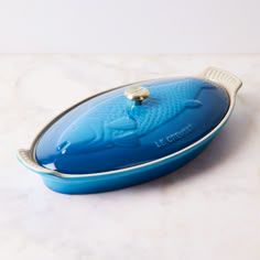 a blue casserole dish sitting on top of a counter