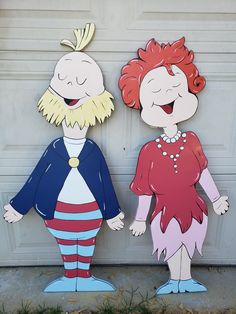 two paper cut outs of people standing next to each other in front of a garage door