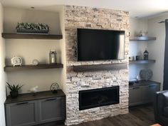 an image of a living room setting with fireplace and entertainment center on the left side