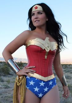 a woman in a wonder costume posing with her hands on her hips