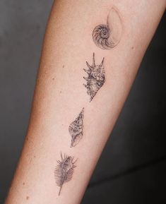 a woman's arm with three different tattoos on it