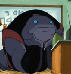 a cartoon character sitting on the floor in front of a desk