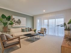 a living room filled with furniture and a painting on the wall