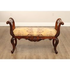 a wooden bench sitting on top of a hard wood floor