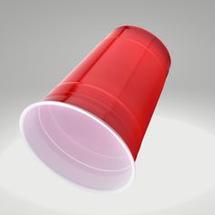 a red plastic cup sitting on top of a white table