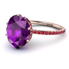 a purple ring with red stones on it