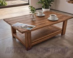 a wooden table sitting on top of a tile floor next to a potted plant