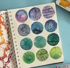 an open notebook with watercolor designs on it