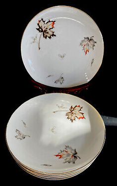 two plates with leaves on them sitting next to each other