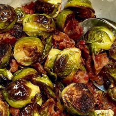 brussel sprouts with bacon are shown in a bowl on the table