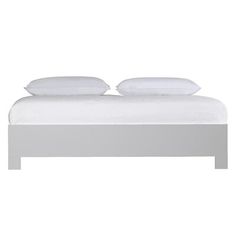 a white bed with two pillows on top of the headboard and foot board, against a white background