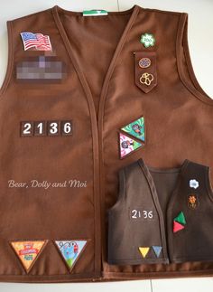 a brown vest with patches and numbers on it