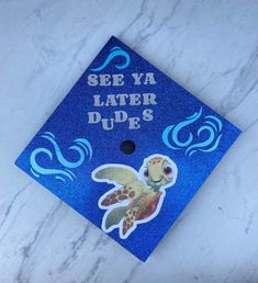 a blue graduation cap that says see ya later dudes with a sea turtle on it