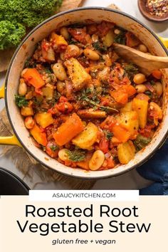 roasted root vegetable stew in a large pot with wooden spoons and vegetables around it