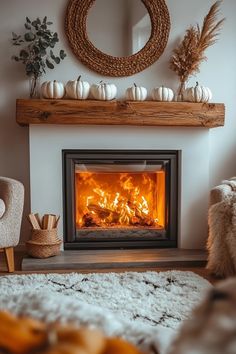 a living room with a fire place in the center and white pumpkins on the mantle