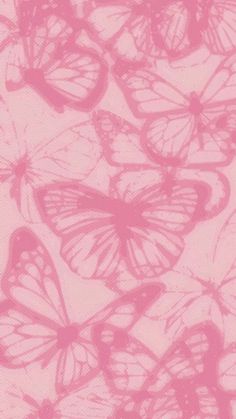 pink butterflies are flying in the air with their wings spread out to form a pattern