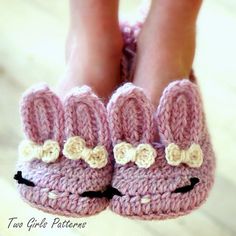 there is a pair of crocheted slippers with ears and bows on them