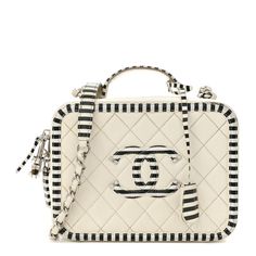 This is an authentic CHANEL Caviar Quilted Striped Medium CC Filigree Vanity Case in White and Black. This chictravel bag is crafted of luxurious diamond quilted caviar leather in ivory with a black and white striped border. This elegant shoulder bag featuresa silver chain-link shoulder strap threaded with white leather, a white and black striped leather top handle, and a striped Chanel CC logo with silver accents on the front. The wrap-around zippers open to a partitioned red leather interior w Luxury Quilted Rectangular Bag, Luxury White Quilted Shoulder Bag, High-end Quilted Rectangular Shoulder Bag, Luxury Quilted Rectangular Shoulder Bag, Elegant White Quilted Bag, Designer White Rectangular Case Bag, Luxury White Rectangular Case Bag, Luxury White Rectangular Shoulder Bag, Designer Quilted Rectangular Shoulder Bag