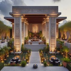 an outdoor dining area is lit up with candles and greenery at dusk, surrounded by potted plants