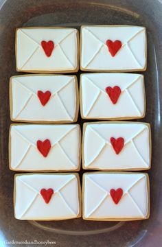 some cookies with hearts on them are arranged in the shape of envelopes