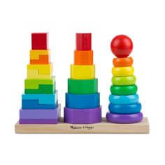 a wooden stacking toy with different colored blocks and an apple sitting on top of it