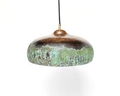 a green and brown light hanging from a ceiling