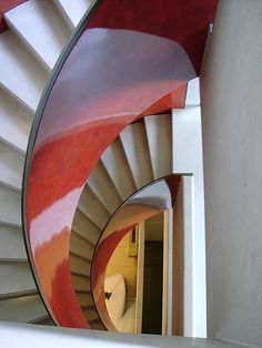 a spiral staircase with red and white paint on it