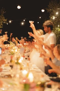 a group of people sitting around a dinner table