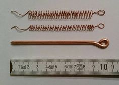 two copper springs and a measuring tape