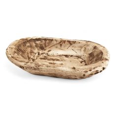 a wooden bowl sitting on top of a white surface