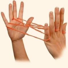 two hands with orange string attached to them