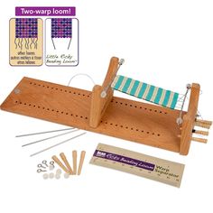 a wooden weaving machine with needles and pins on it's side next to a ruler