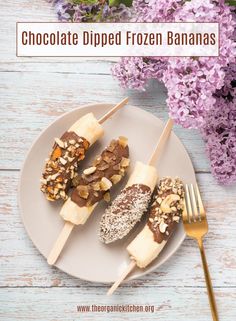 chocolate dipped frozen bananas are on a plate with a fork and purple flowers in the background