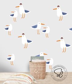 seagulls wall decals in various sizes and colors are on the wall next to a basket