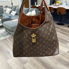 Discontinued Authentic Lv Bag In Great Condition. Rectangular Monogram Canvas Bag With Lock, Luxury Brown Shoulder Bag With Lock, Brown Bags With Lock For Everyday Luxury, Designer Shoulder Bag With Lock For Daily Use, Brown Bag With Lock For Daily Use, Brown Bag With Lock For Everyday Use, Brown Tote Bag With Lock, Brown Everyday Bag With Lock, Luxury Brown Hobo Bag With Branded Hardware