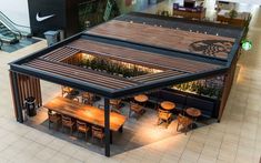 an overhead view of a restaurant with wooden tables and benches in the middle of it