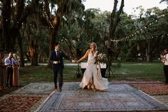 a bride and groom walking down the aisle at their outdoor wedding ceremony in charleston, sc