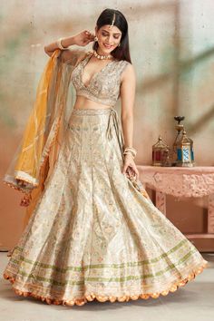 Go for a beautiful traditional look at weddings in this sage green embroidered Banarasi silk lehenga. The lehenga comes with a beautiful dupatta. Disclaimer: The actual product may vary slightly from the image. These are custom orders, hence expect slight variation in color, placement of the motif or buta. ESTIMATED DELIVERYBecause this is a custom order, it would take about 4 weeks from the date of purchase. RETURN POLICYThis product is a custom order and cannot be returned or exchanged. Fitted Brocade Lehenga With Meenakari Details, Pista Green Lehenga With Meenakari, Traditional Drape, Designer Meenakari Lehenga In Pista Green, Green Brocade Sharara For Wedding, Pista Green Silk Lehenga With Intricate Embroidery, Pista Green Banarasi Silk Wedding Set, Green Brocade Anarkali Set For Wedding, Pista Green Meenakari Wedding Sets, Pista Green Raw Silk Lehenga For Wedding