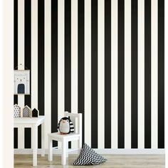 a black and white striped wallpaper in a child's room with two small tables