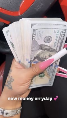 a person holding money and a toothbrush in their hand