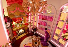 a living room filled with lots of furniture next to a pink and yellow wall mounted clock