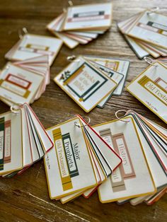 many tags are laid out on a wooden table