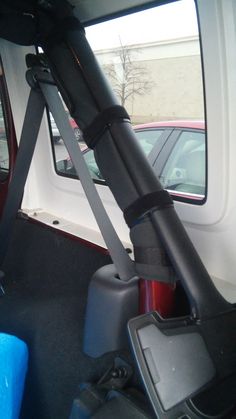 the back seat of a vehicle with luggage strapped to it