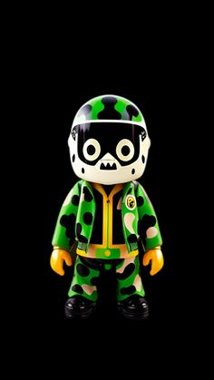 a green and black teddy bear with a helmet on it's head, standing in front of a black background