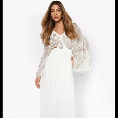 Embellished Ivory Gown For Wedding, Bridesmaids Glamorous V-neck Wedding Gown, White Evening Dress For Wedding Guest During Prom Season, Cream Floor-length Prom Dress, V-neck Maxi Dress With Sheer Bodice For Wedding, Sequined Maxi Dress For Wedding, Cream Maxi Dress For Prom, Floor-length Prom Dress With Pearl Embroidery, V-neck Sequin Wedding Gown, Sequined V-neck Wedding Gown