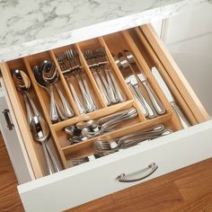 an open drawer with silverware in it