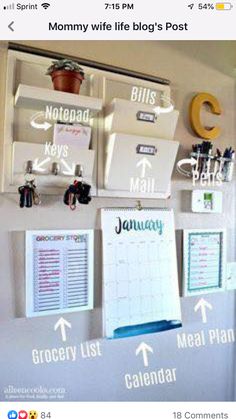 an organized calendar hangs on the wall with magnets and clipboards attached to it