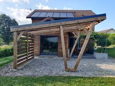 a wooden structure with solar panels on the roof