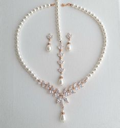 a necklace and earring set with pearls