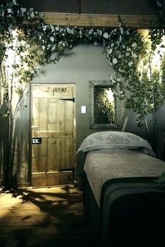 a room with a bed and plants growing on the wall next to it's door